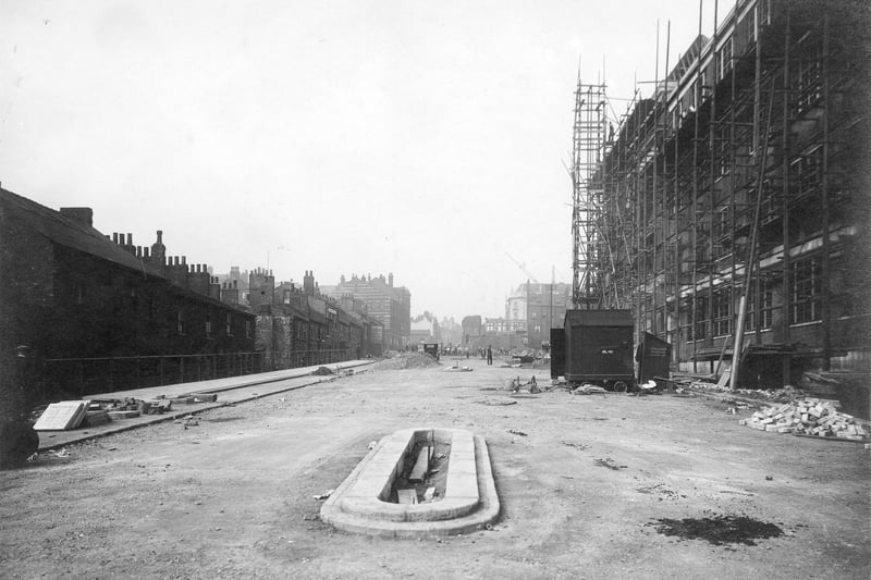  Looking from end of Woodhouse Lane towards the Headrow, on the right side of centre is the end of the new Permanent House block of buildings (white). Building work is in progress, on the right, workmen, tools and building materials can be seen. Pictured in September 1931.