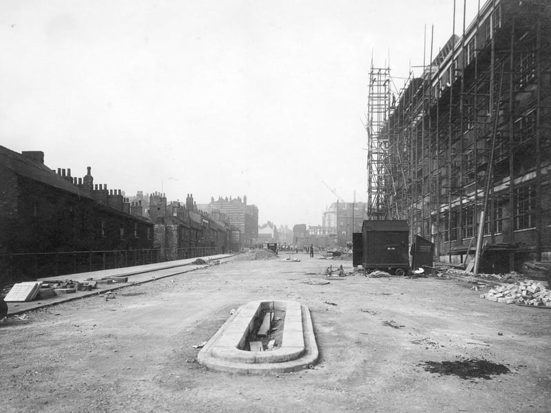  Looking from end of Woodhouse Lane towards the Headrow, on the right side of centre is the end of the new Permanent House block of buildings (white). Building work is in progress, on the right, workmen, tools and building materials can be seen. Pictured in September 1931.
