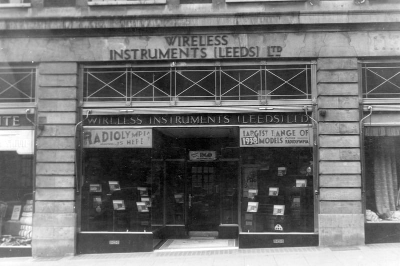 Wireless Instruments (Leeds) Ltd shop, with wireless sets displayed in the windows. Sticker in the window states 'Largest range of 1938 models outside Radiolympia'. Pictured in September 1937.