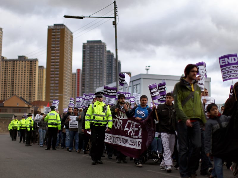 Local people hold a rally from the Red Road flats in memory of three Russian asylum seekers in March 2010. Around 200 people marched to the city's George Square, from the flats where the asylum seekers apparently jumped to their deaths.
