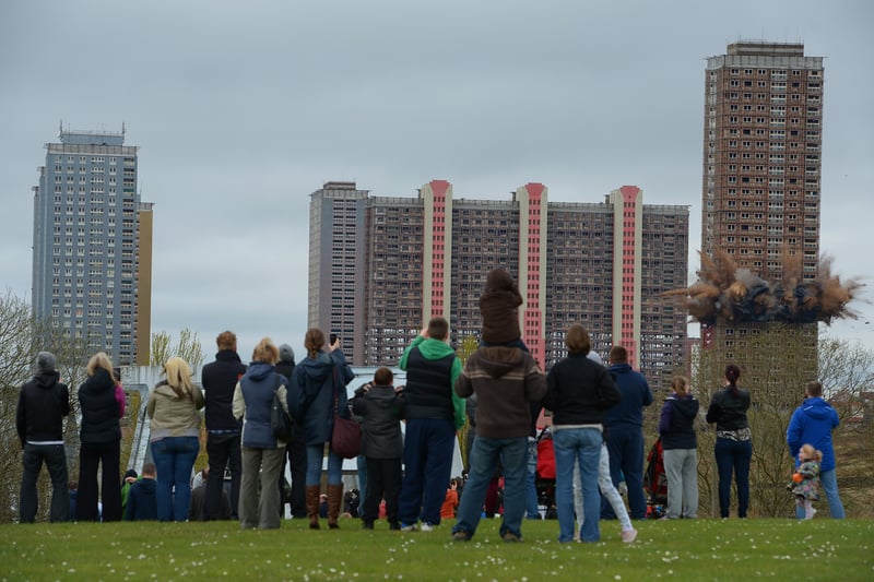 Members of the public look on as the thirty story tower block at Birnie Court is demolished on May 5, 2013 in Glasgow. 