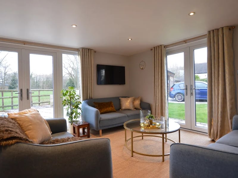 The sitting room provides access to the expansive grounds of the property.