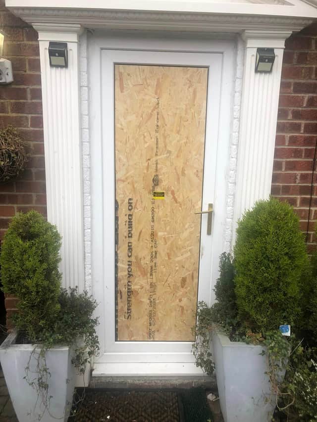 The couple's front door has been boarded up temporarily.