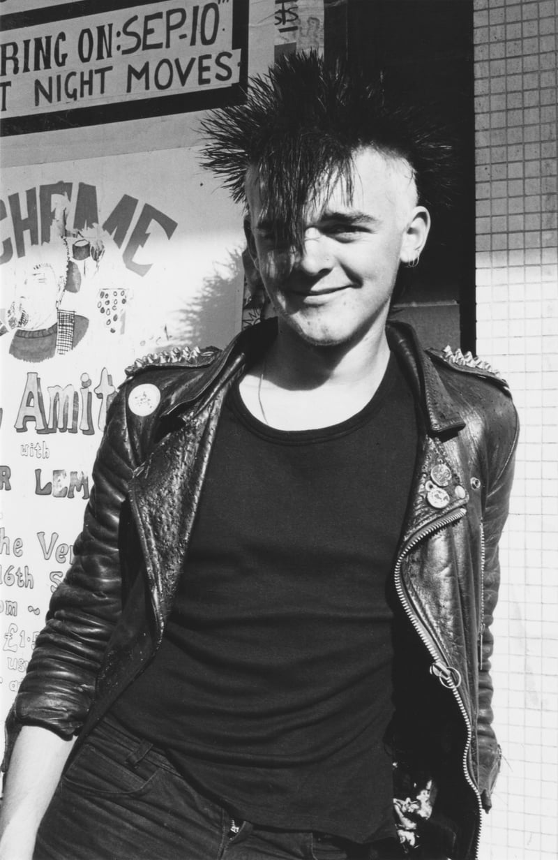 A young punk looking pretty pleased with himself - you can see a poster advertising a Scheme + Del Amitri gig in the background in the record store window.
