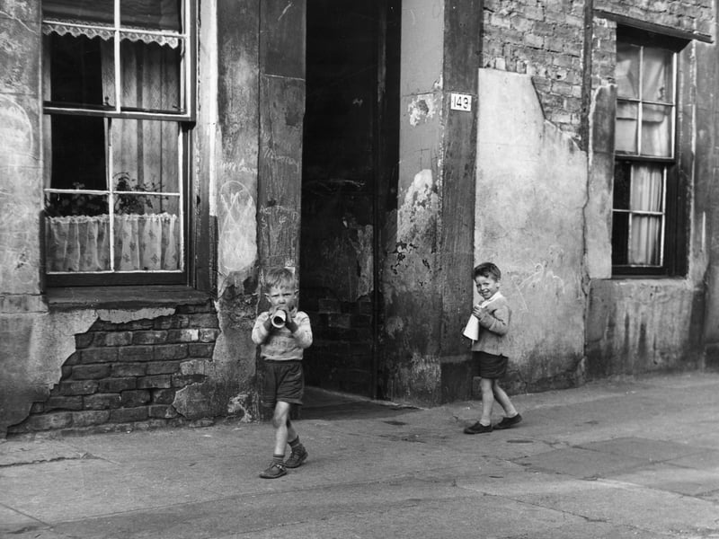 Two young boys playing outside in the Gorbals district of Glasgow.