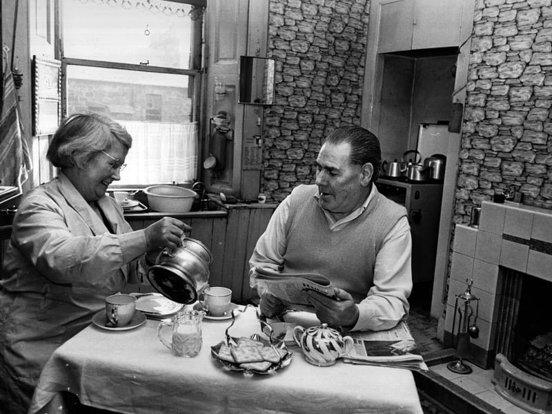 Mr and Mrs Curran sitting having tea in the kitchen of their soon-to-be-demolished tenement home in the Gorbals area of Glasgow. 