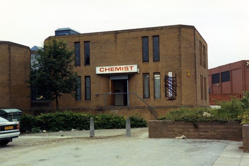 A chemist which forms part of the Fraternity House complex on Church Street. Morrison's supermarket can be seen on the right. Pictured in May 1990.