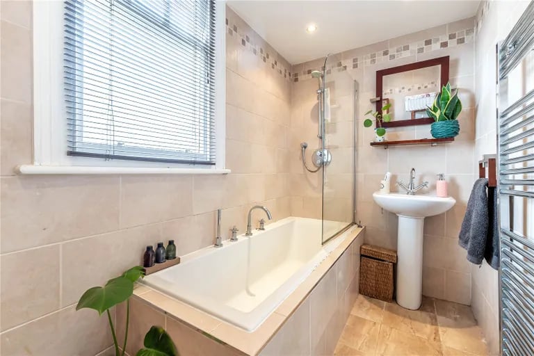 The tiled family bathroom features a three piece suite.