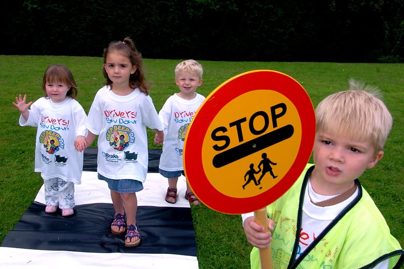 Toddlers taking part in Beep Beep Day at Cookridge Village Hall in September 32005. This was an initiative by national road safety charity Brake. They are lollipop man Miles Hudson, with from the left, Carys McDonald, Frankie Brown and Max Thomas.