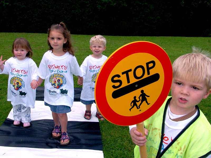 Toddlers taking part in Beep Beep Day at Cookridge Village Hall in September 32005. This was an initiative by national road safety charity Brake. They are lollipop man Miles Hudson, with from the left, Carys McDonald, Frankie Brown and Max Thomas.