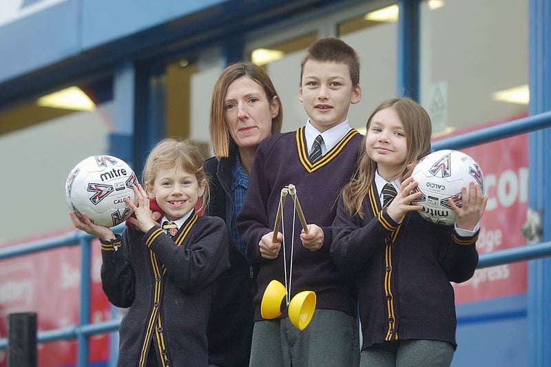 Holy Trinity Primary School pupils in February 2006 with equipment received through Tesco's sports vouchers for schools scheme. Pictured, from left, are Phoebe Lister, Lisa McManus of Tesco, Murphy Boreham and Alex Atkinson. 