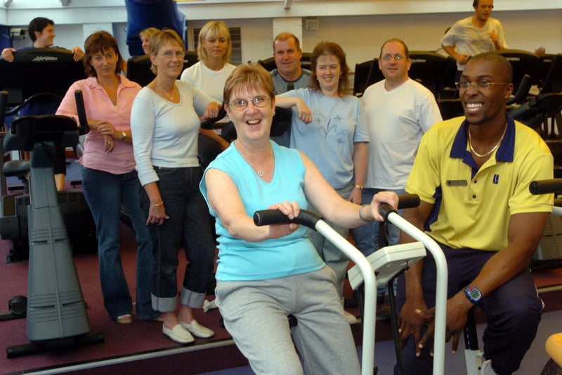 Fitness instuctor, Mike Hendicks, of Esporta gym in Cookridge puts Anita Butcher through some exercises watched by her colleagues from Cookridge Hospital who were preparing for  charity trek to China. Pictured in August 2004.