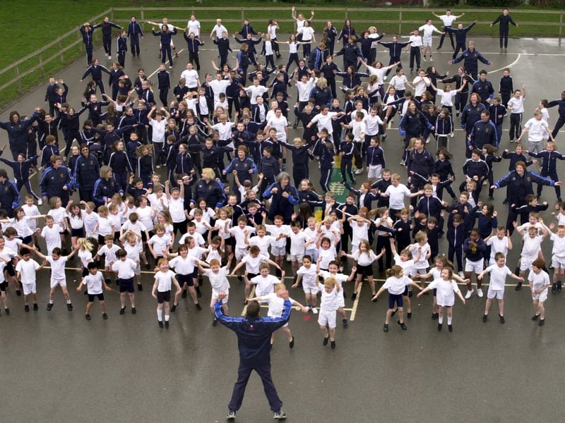 Pupils and staff take part in an outdoor sports lesson at Holy Trinity Primary School in March 2004.