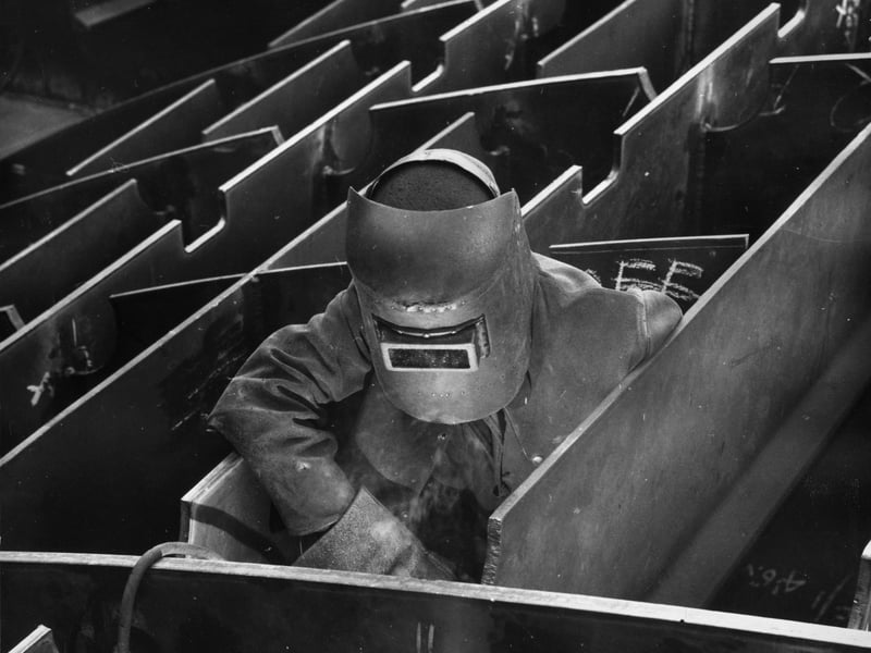 A welder working inside a prefabricated section of the new Cunard liner at John Brown's shipyards in Glasgow. John Brown's yards were the most famous on Clydeside and produced many liners including the 'Aquitania' and the 'Queen Elizabeth'.