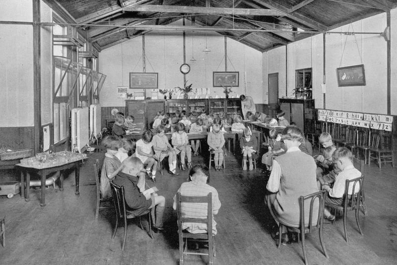 A room in the junior section of West Leeds High School circa 1940s  - the only place in the school where boys and girls were permitted to mix. The children are all seated and reading.