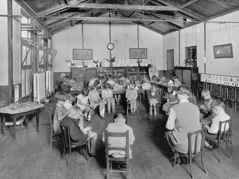 A room in the junior section of West Leeds High School circa 1940s - the only place in the school where boys and girls were permitted to mix. The children are all seated and reading.