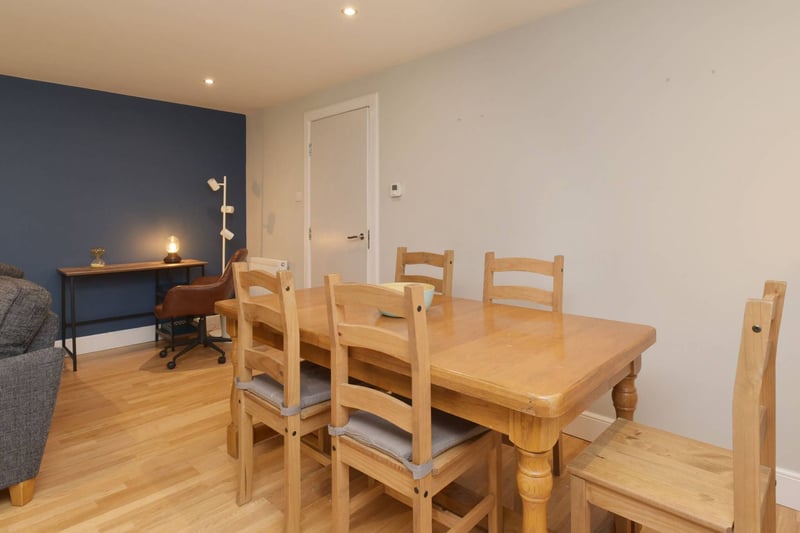 The internal accommodation is focused on a spacious open-plan living room and kitchen, including this dining area.