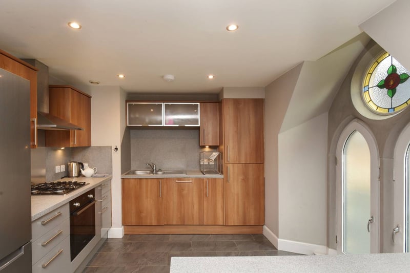 The modern kitchen is comprised of a full range of base and wall-mounted units that offer excellent prep and storage space. Gas hob, electric oven, and dishwasher are integrated and space is provided for a free-standing fridge freezer. Laundry facilities are in a separate utility cupboard.