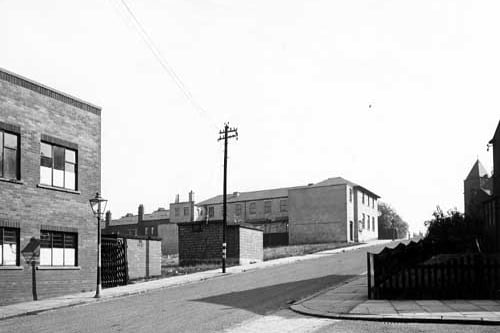 A view looking south up Hall Road towards the Air Raid Warden's post. A streetlamp and a telephone pole are prominent. Pictured in September 1945.