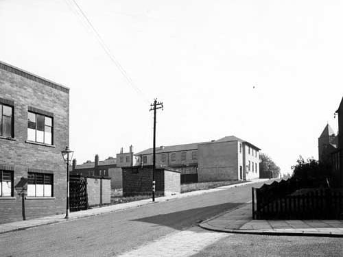 A view looking south up Hall Road towards the Air Raid Warden's post. A streetlamp and a telephone pole are prominent. Pictured in September 1945.