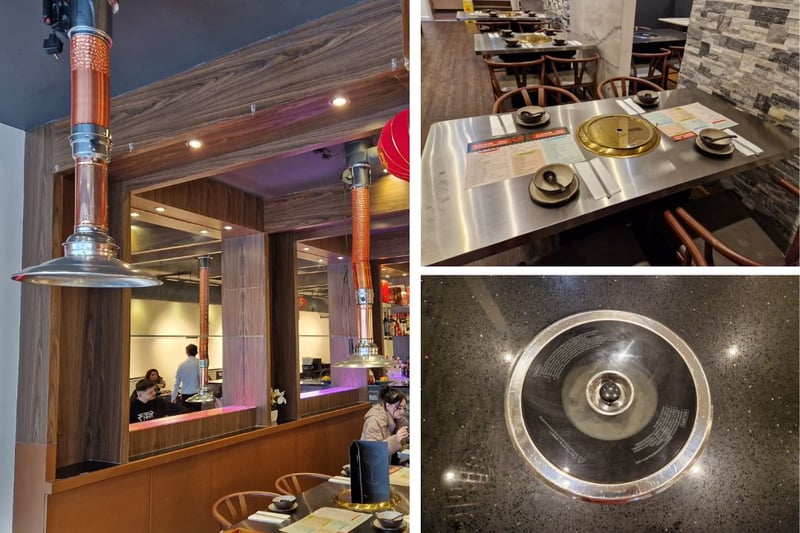 Tables on both floors are equipped with cooking plates in the centre, and adjustabke heat lamps hang above