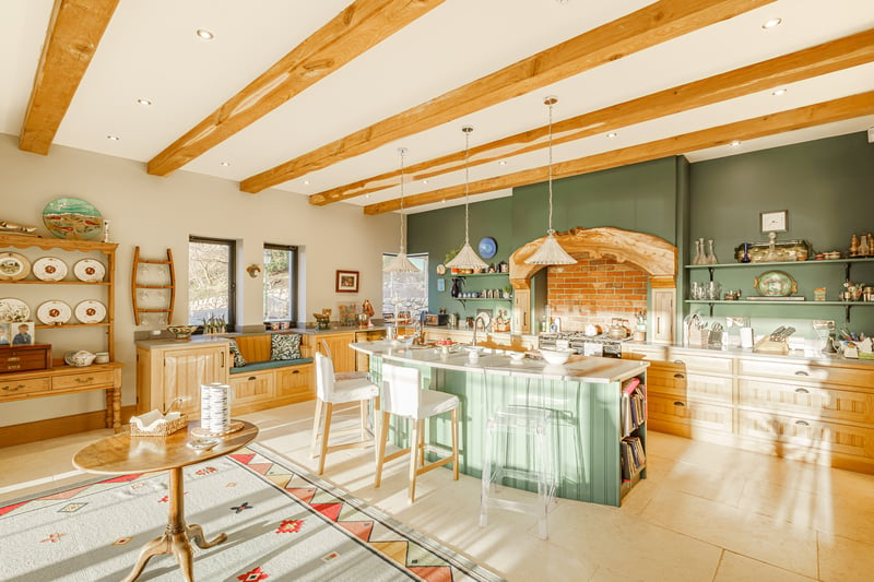 The kitchen, which contains
exposed wooden beams and a range cooker surrounded by an elm feature arch, was handmade by Dumfriesbased Hiddleston Joiners and boasts a grand limestone archway.
Gail recalls: “I actually saw it on Pinterest and asked our builders if they could source that for me, which they did, and it is absolutely beautiful.
“We have enjoyed all of the views because every window looks over the loch. All the bedrooms and our three
sitting rooms have different views over the water, which is something we will really miss.”
