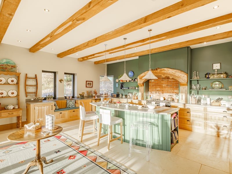 The kitchen, which contains
exposed wooden beams and a range cooker surrounded by an elm feature arch, was handmade by Dumfriesbased Hiddleston Joiners and boasts a grand limestone archway.
Gail recalls: “I actually saw it on Pinterest and asked our builders if they could source that for me, which they did, and it is absolutely beautiful.
“We have enjoyed all of the views because every window looks over the loch. All the bedrooms and our three
sitting rooms have different views over the water, which is something we will really miss.”
