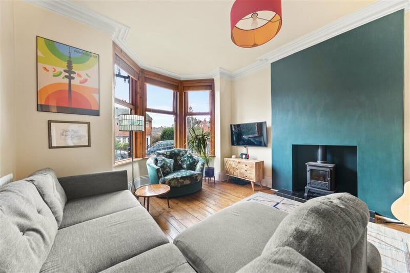 To the front is a spacious living room with bay window and logburner.