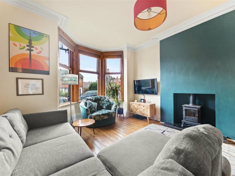 To the front is a spacious living room with bay window and logburner.