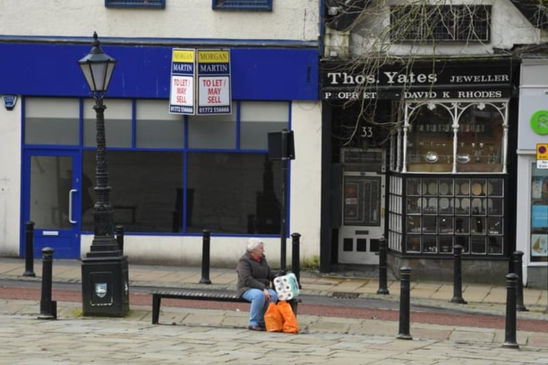 A lucky shopper who got their hands on some toilet roll takes a breather on the empty Flag Market