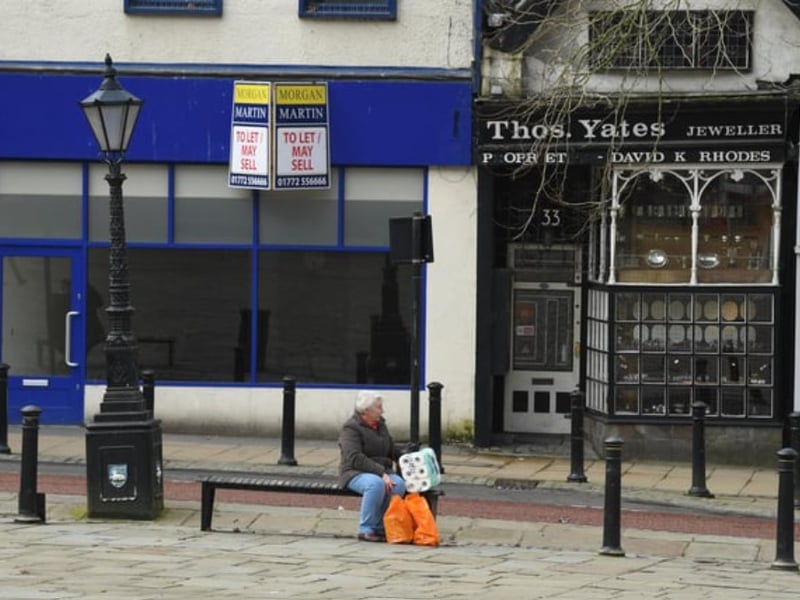 A lucky shopper who got their hands on some toilet roll takes a breather on the empty Flag Market