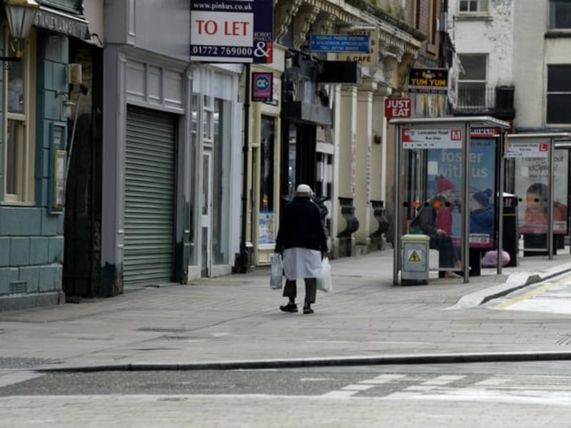 A lone shopper makes their way up Lancaster Road