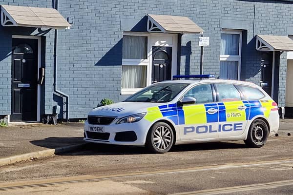 A picture shows a police car parked outside the complex. Photo: David Kessen, National World