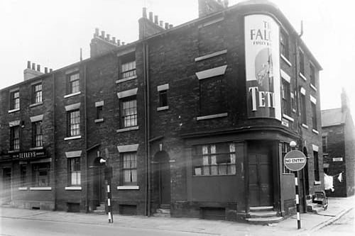 The Falcon Inn is at number 7 Great Wilson Street, on the left. Next 9, 11 and 13. This is the property at the corner with Church Cross Street. There is a large poster advertising Tetley beers,served at the Falcon Inn. On the right edge, Bywater Street can be seen, lying behind Great Wilson Street. Pictured in June 1959.