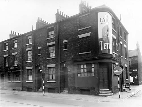 The Falcon Inn is at number 7 Great Wilson Street, on the left. Next 9, 11 and 13. This is the property at the corner with Church Cross Street. There is a large poster advertising Tetley beers,served at the Falcon Inn. On the right edge, Bywater Street can be seen, lying behind Great Wilson Street. Pictured in June 1959.