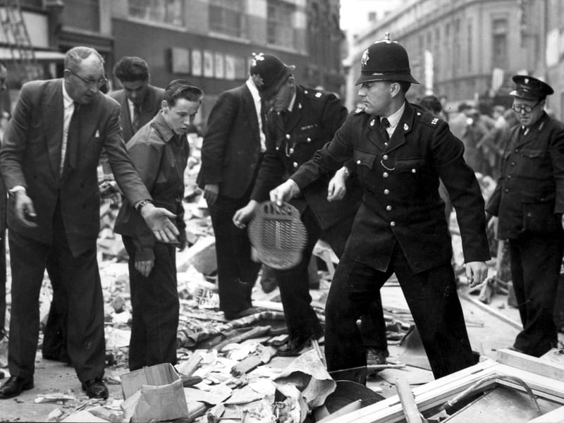 Police join in the grim task of sifting through the Redman's cafe ruins