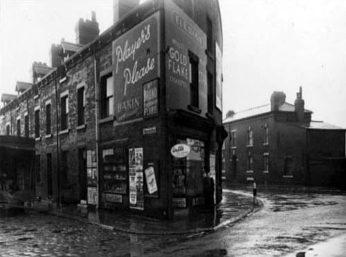 This photo from January 1954 shows number 188 Church Street, at the corner with Bedford Row. The premises of 'E & R Dakin, Newsagents', is visible in the centre of the photo. Adverts for Players Please, Walls ice cream, Robin cigarettes, Evening Post, St Bruno, flake tobbacco, and many more are visible outside the shop. Two boys are stood out the front of the shop looking at the camera. To the left is a lorry with the back open for deliveries.