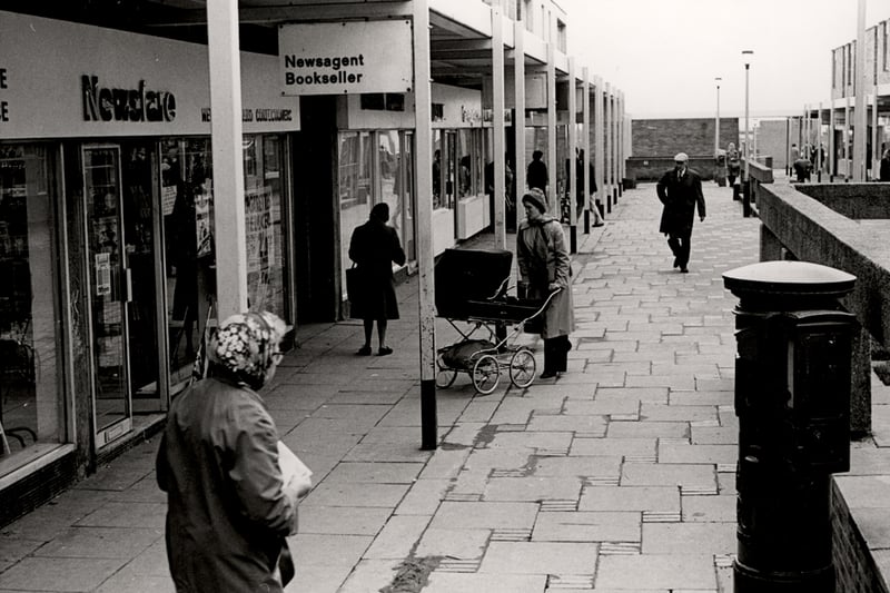  A view of Newbiggin Hall Shopping Centre Newbiggin Hall Estate taken in 1978. The photograph is looking down one of the malls of the outdoor shopping centre. Built in the early 1960's with a variety of accommodation a shopping centre, library, doctors, schools etc.