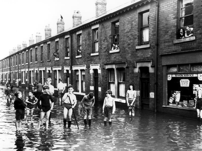 Kids play in the street during flash floods