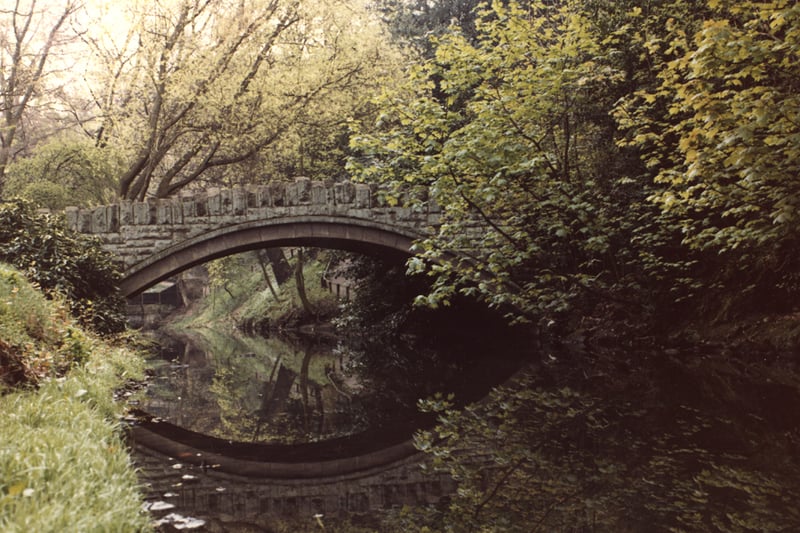  A view of Jesmond Dene Newcastle upon Tyne taken in 1978. The photograph shows one on the stone bridges across the river. The reflection of the bridge can be seen in the water.Jesmond Dene was donated to the city by Lord Armstrong in 1883.