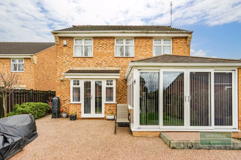 The conservatory extension features double doors that open onto the garden.
