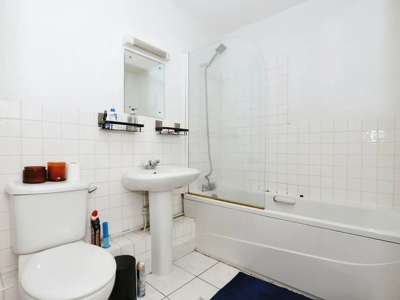 The bathroom is well-equipped with toilet, sink and shower/bath facilities.