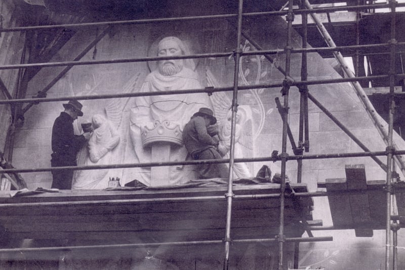 Stone Sculptors at work on the exterior of the chapel of Our Lady of Lourdes, in 1956