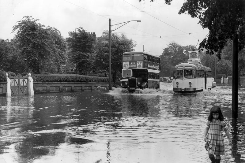 An incoming Ribble bus ploughs through flooded Whitegate Drive overtaking a tram on the Marton route near the junction with St Ives Avenue in July, 1956