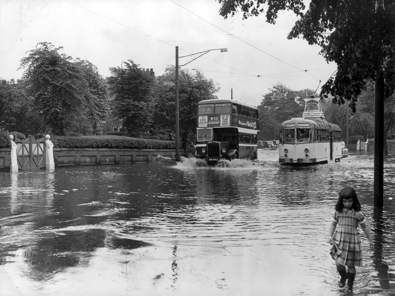 An incoming Ribble bus ploughs through flooded Whitegate Drive overtaking a tram on the Marton route near the junction with St Ives Avenue in July, 1956