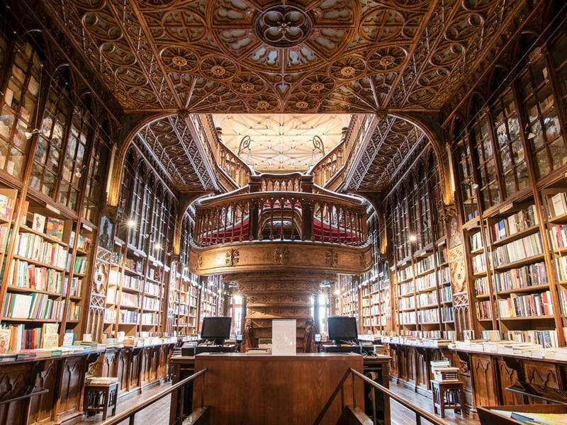One glimpse of Livraria Lello’s 1906 Neo-Gothic façade and ornate interior and you’ll understand why it’s the 3rd most Instagrammed bookstore in the world. Visitors are enchanted by the stained glass ceilings, opulent woodwork, and the Grande Galeria's ruby-red staircase that rises through the centre like a fantastical book tower.