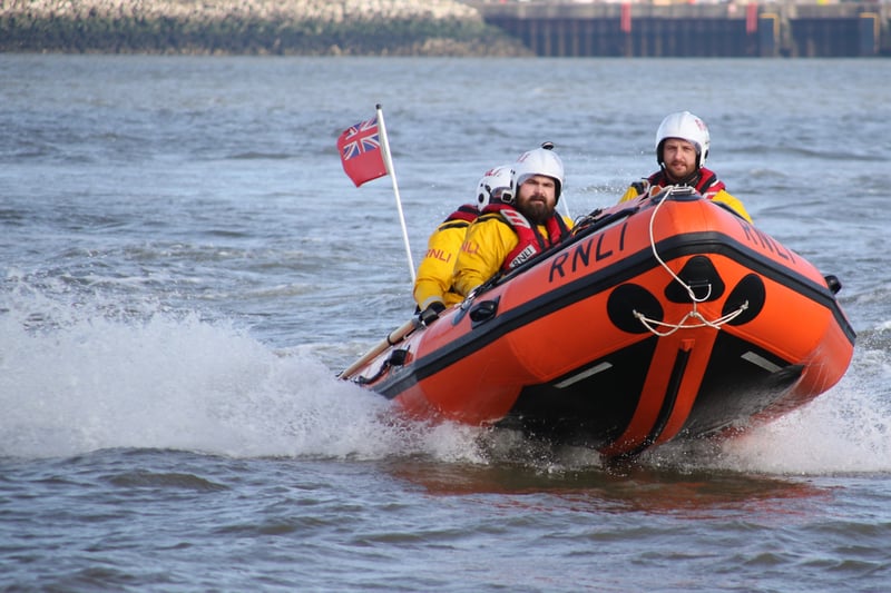 A lifeboat powers down the Mersey during the RNLI's 200th anniversary. 