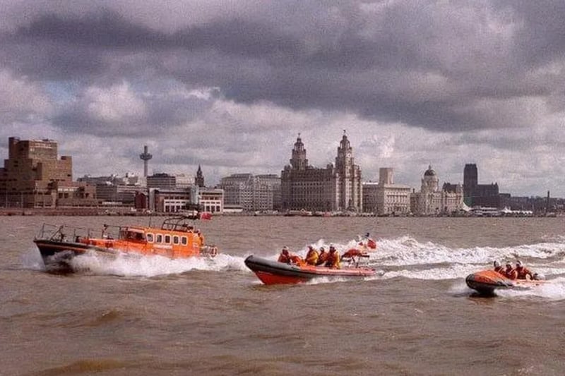 The RNLI lifeboat flotilla is photographed on the Mersery 25 years ago, with the Liverpool skyline in the background.