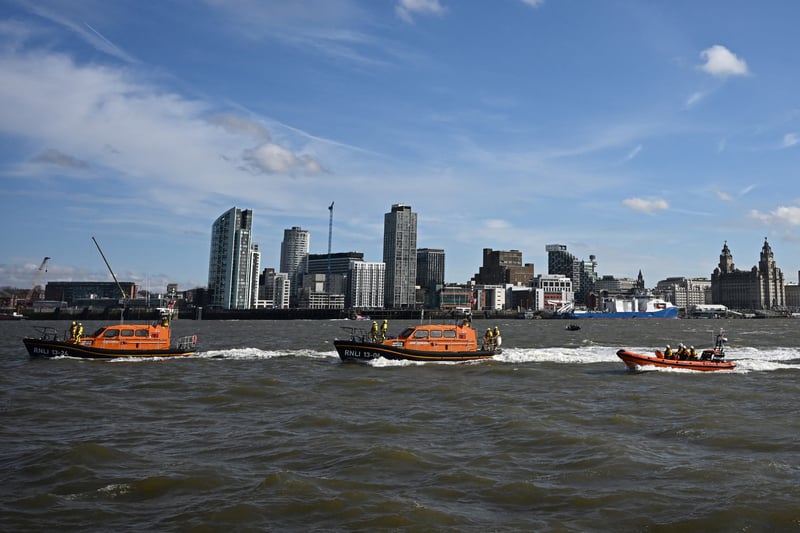 Lifeboats from Lytham St Annes, Hoylake, New Brighton and West Kirby form a flotilla in the River Mersey with Liverpool's skyline in the background - recreating the image from 25 years ago.