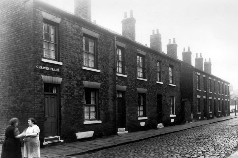 Odd numbered back-to-back houses on Greaves Place, numbers run to the right in ascending order from number 1 on the left where two ladies can be seen chatting. Pictured in October 1958.